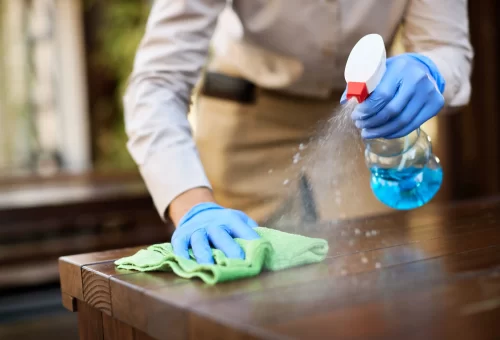 closeup-waitress-disinfecting-tables-outdoor-cafe-scaled